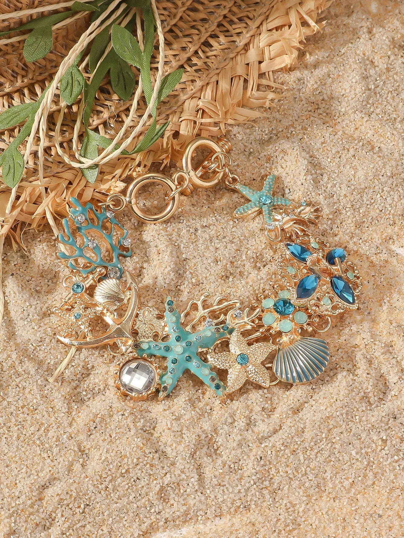 Women's alloy rhinestone nautical bracelet with starfish and anchor charms in turquoise, red, or blue.