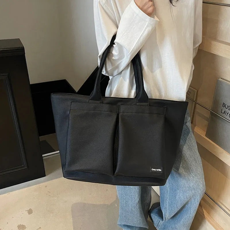 Lightweight expandable shoulder bag in solid colour with ventilation feature