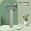 Green and grey dog de-matting combs in large and small sizes on a white background.