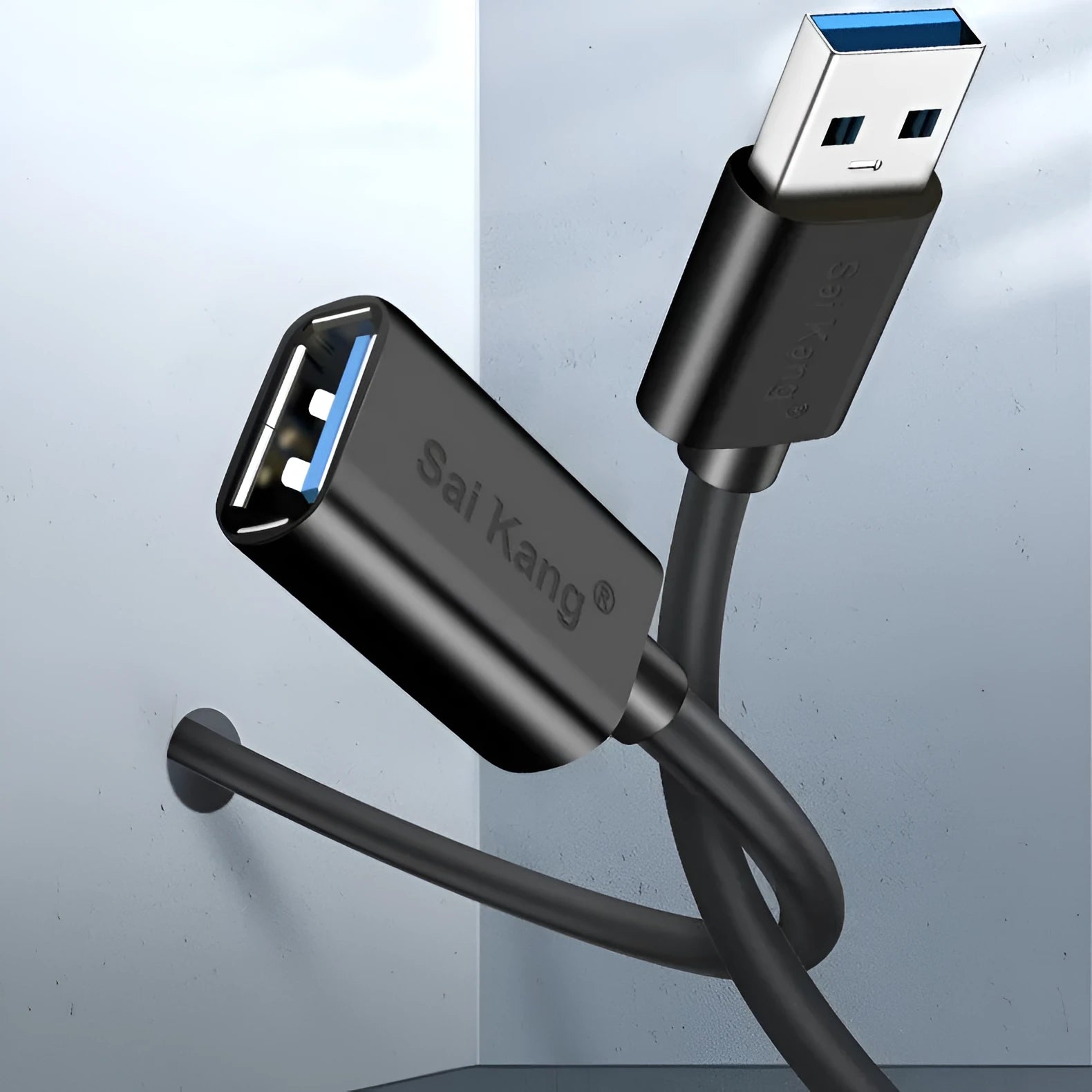 Black USB male to female extension cable on a desk, showing connector ends.