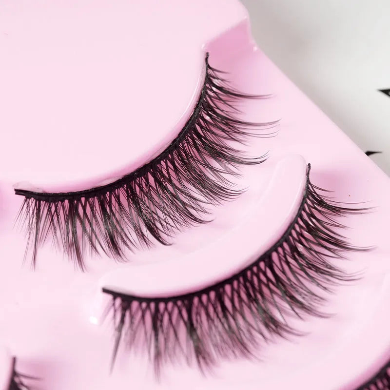 Bundle of manga false eyelashes showing three wispy styles 007, 008, and 009 on a black plastic terrier strip.