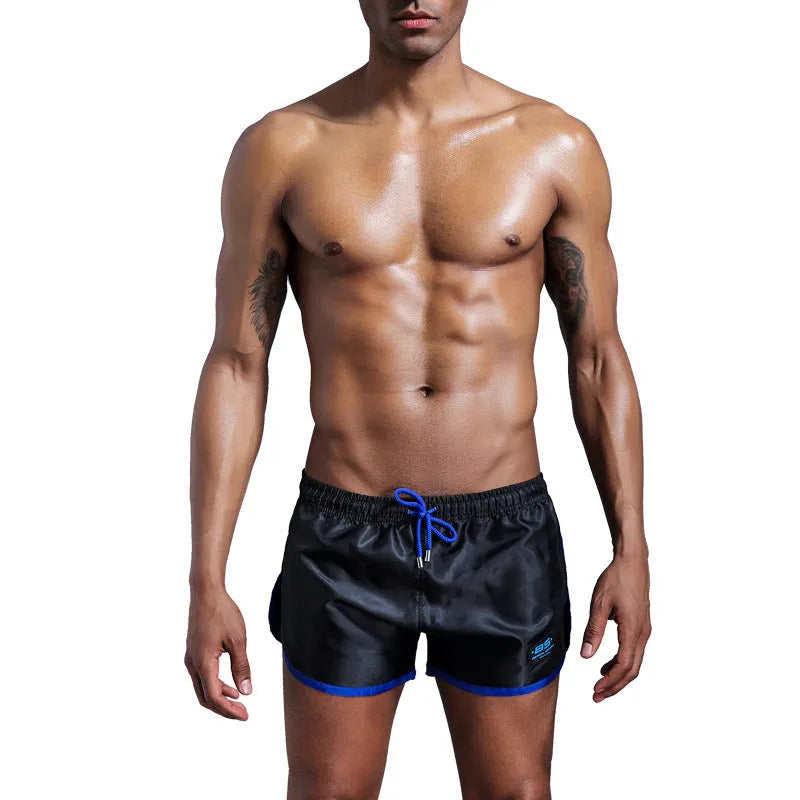 Men's solid colour polyester sports shorts in blue showing smooth beach pants design for fitness and swimming