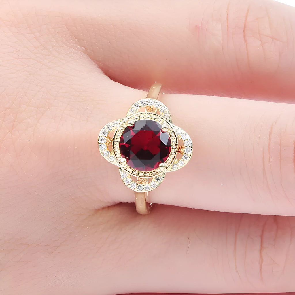 Copper fruit-shaped ring with a zircon stone, shown on a finger.