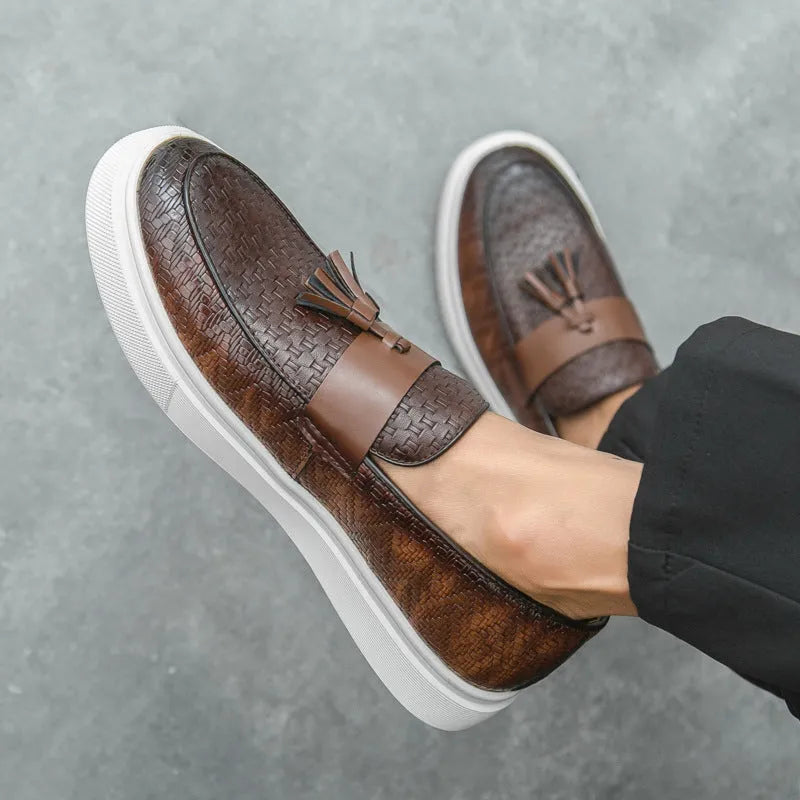 Men's black casual leather shoes with fringe detailing on the upper, round toe, and low heel.