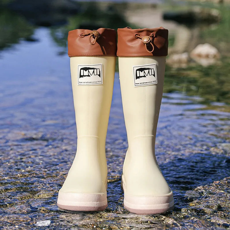 Solid colour high tube PVC rain boot in beige, shown on a white background.
