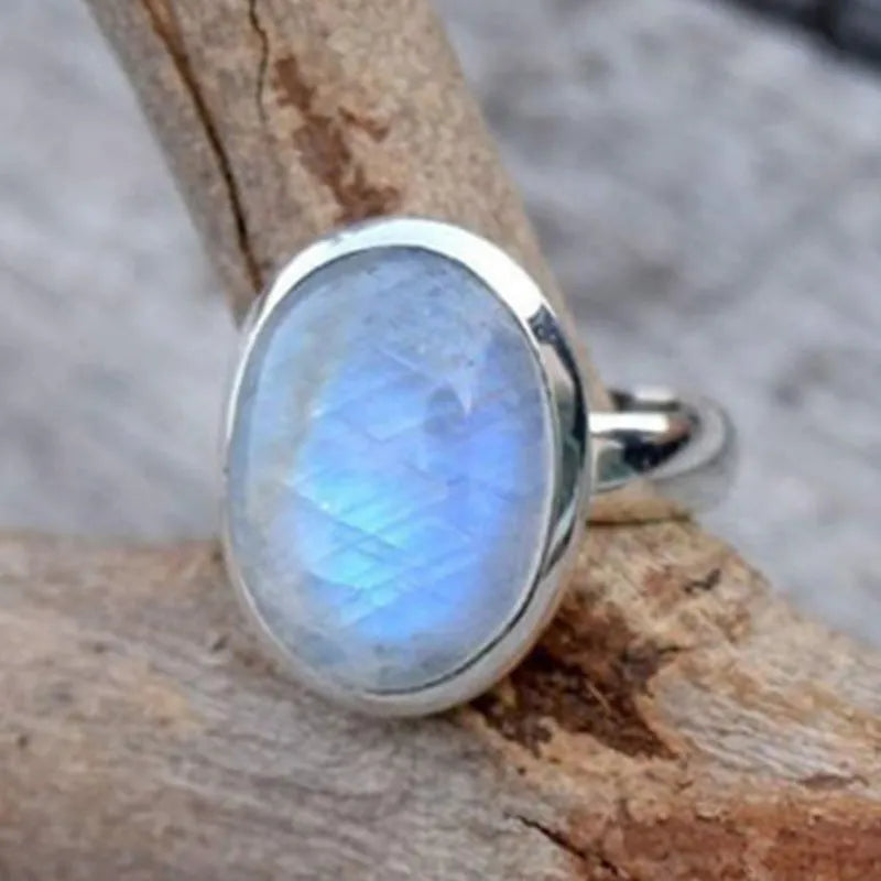 Silver alloy vintage Thai moonstone flower ring for women on plain background