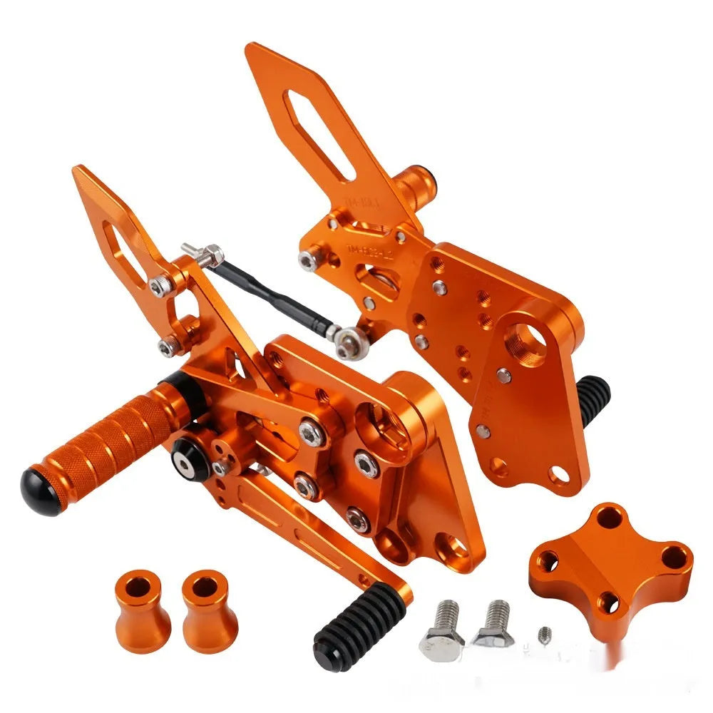Black and orange KTM Duke motorcycle rear shift pedal support bracket assembly.