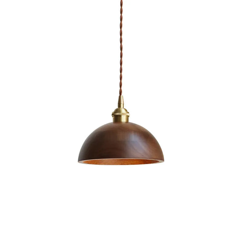Black walnut and copper single-head droplight chandelier suspended from a ceiling.