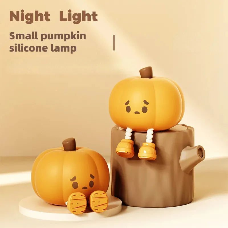Soft orange silicone pumpkin-shaped night light with a gentle glow, sitting on a surface.