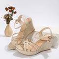 Women's black wedge sandals with fish mouth open toe and cloth upper on a white background.