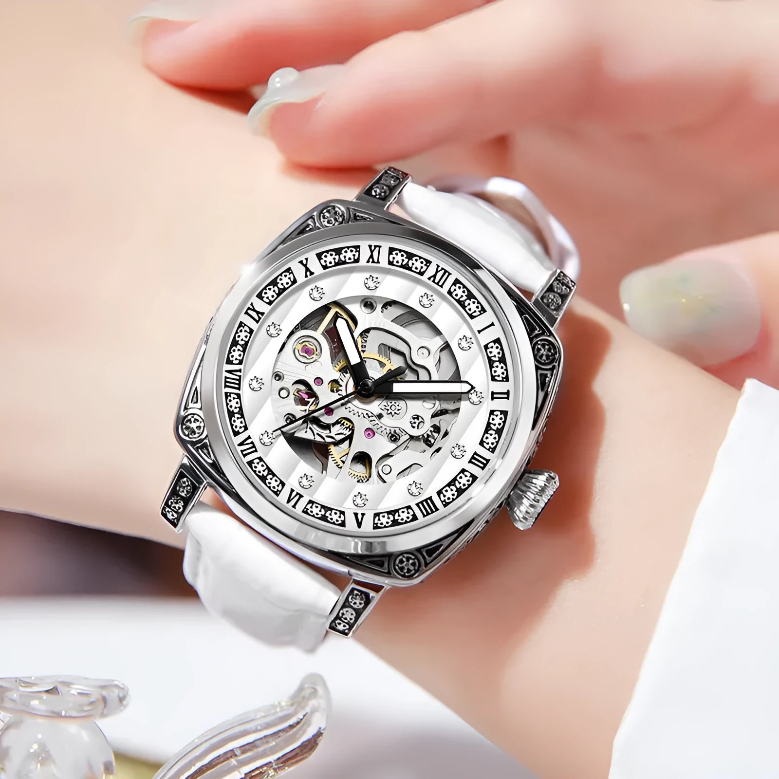 Mechanical watch with luminous hands and a leather strap on a wrist, showing black case variant.