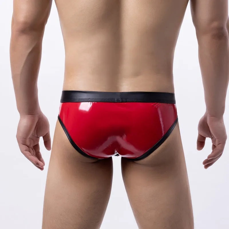 Man wearing low-waist gold bikini swim briefs on beach