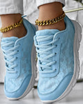 Women's white canvas sports shoes with a flat heel and round toe on a plain background.
