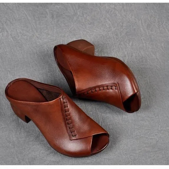 A pair of women's black square heel peep-toe slippers with an open fish mouth design.