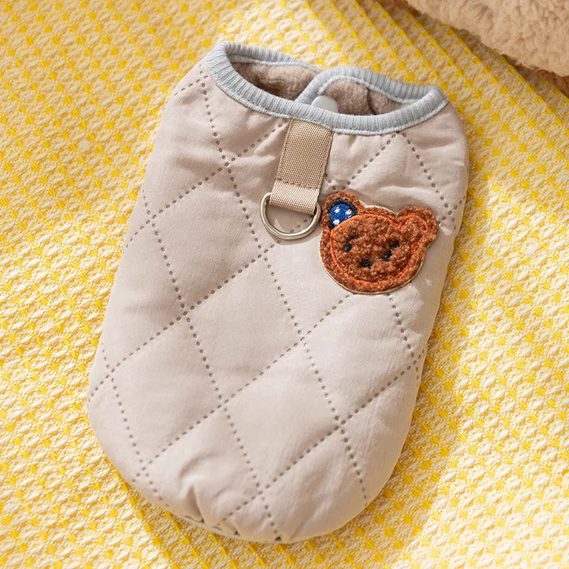 Quilted pet vest with bear patch embroidery on cream background for small dogs