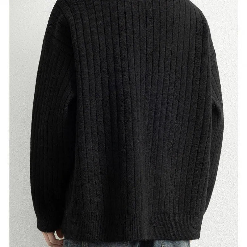 A grey men's loose fit half zip sweater with a textured knit and long sleeves on a plain background.