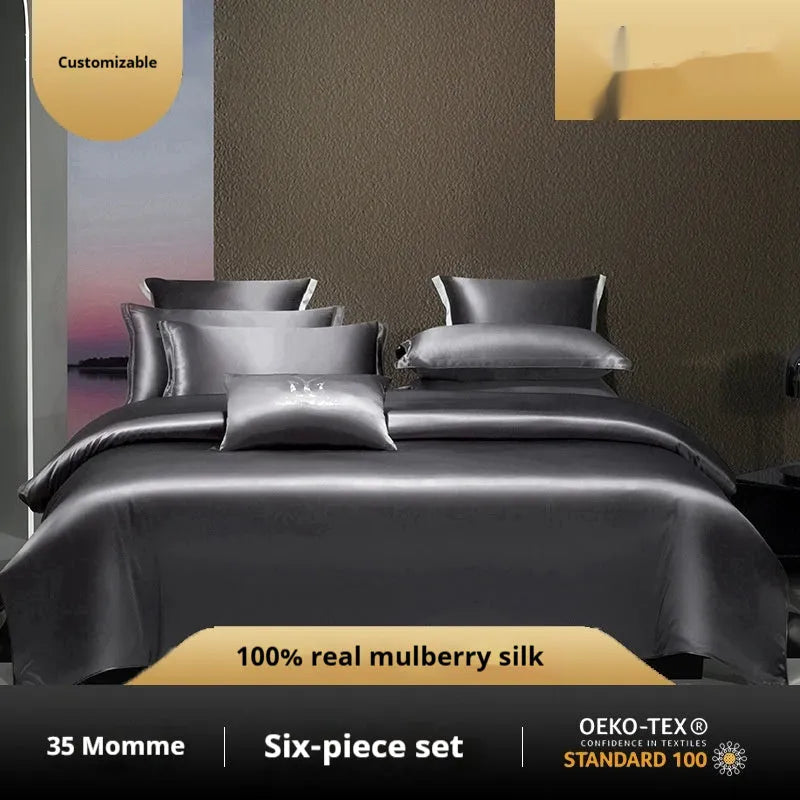 Silk four-piece bedding set in a solid colour, showing quilt cover and pillowcases on a bed.