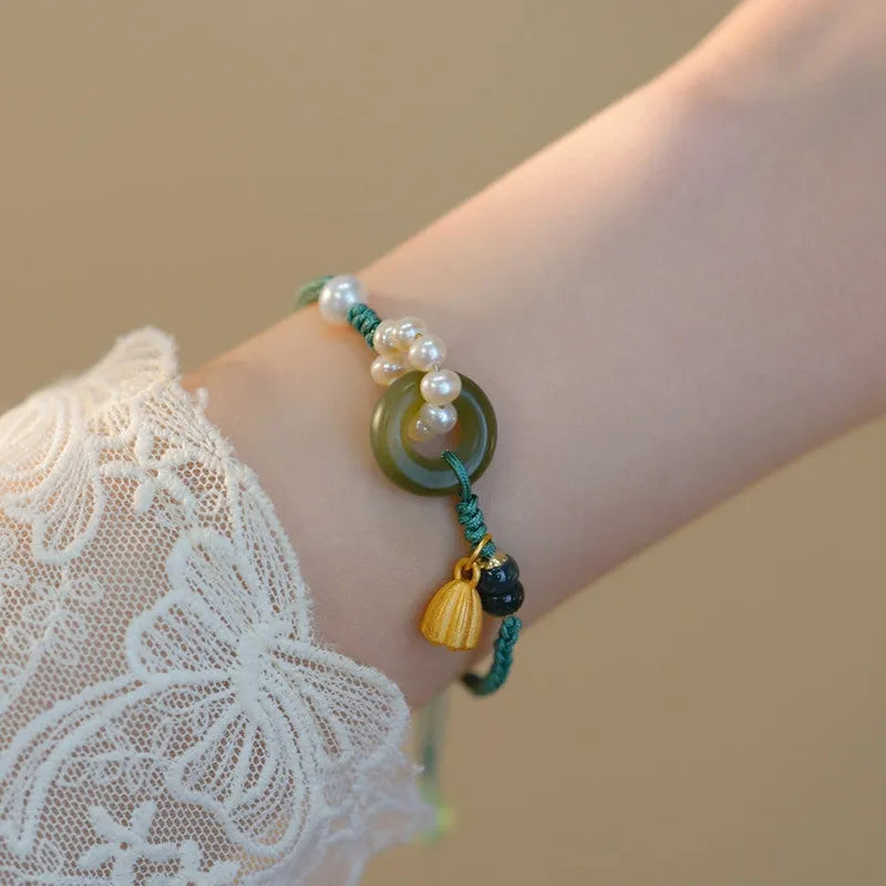 Hand-woven flexible wire watch bracelet with pearl peace buckle closure on wrist
