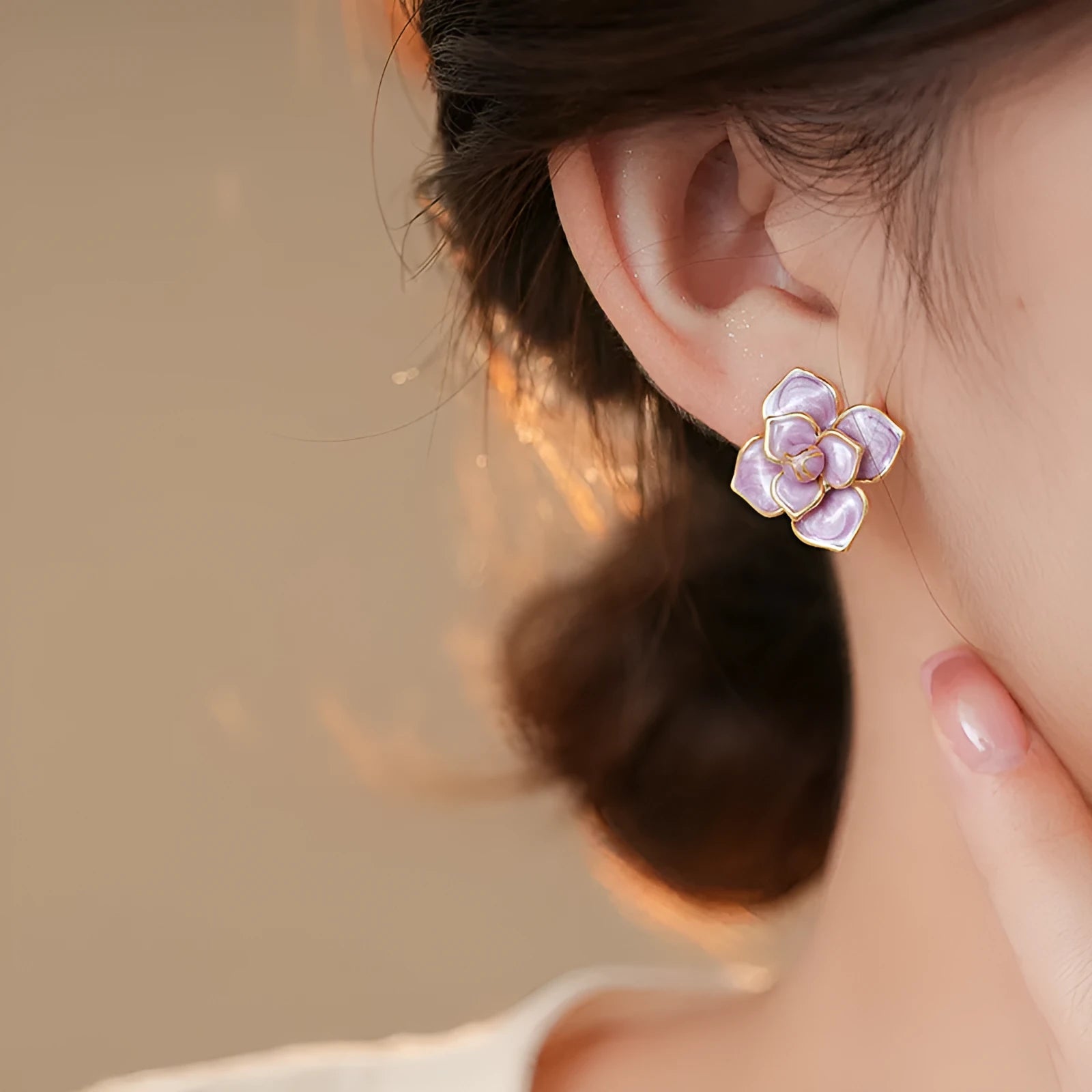 Gold plated purple oil-spot glaze 3D flower stud earrings with surgical steel posts on a white background.