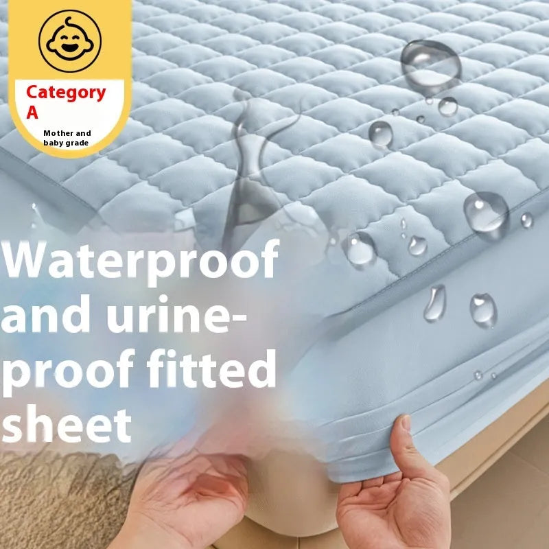 Class A waterproof fitted sheet in washed cotton, shown in a neutral colour on a bed.