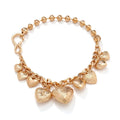 Gold tone carved heart-shaped pendant on an adjustable metal chain necklace.