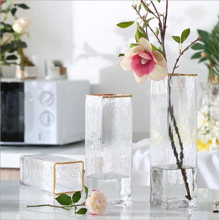 Set of three transparent gold-painted glass vases in 8x20CM, 8x25CM, and 8x30CM on a table