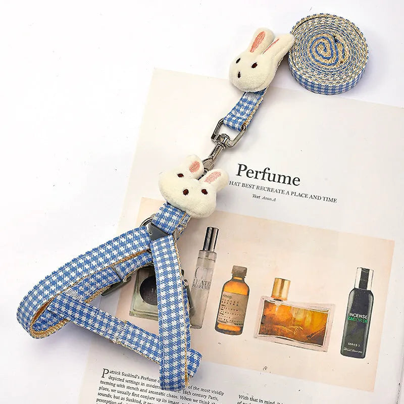 Blue nylon harness and leash set for a small dog, showing quick-release buckles.