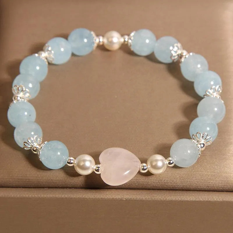 Natural aquamarine crystal bracelet with three shell pearls and lobster clasp on display