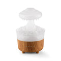 Wood grain white rain cloud humidifier diffuser with glowing LED light and water droplets.