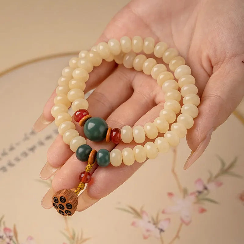 Women's cream topaz Bodhi wooden bracelet with flat round beads on a 15-20cm wrist.