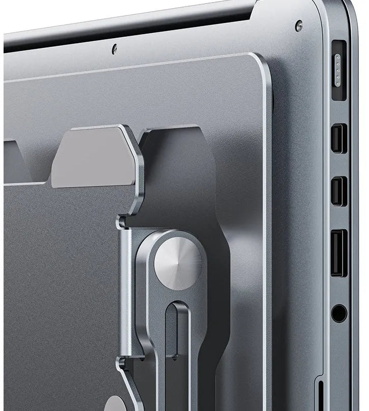 Grey portable aluminum laptop stand with adjustable angle, shown holding a silver laptop.