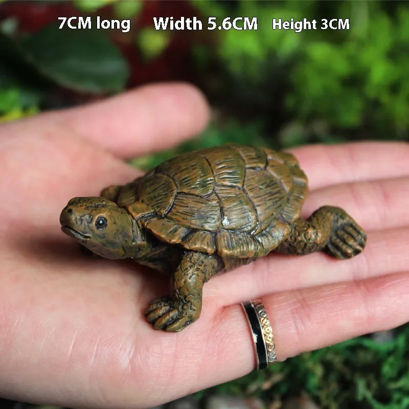 Close-up of a detailed brown resin turtle ornament for miniature garden displays.