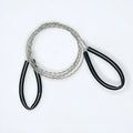 Close-up of a black and red stainless steel survival wire saw coiled in its storage bag.
