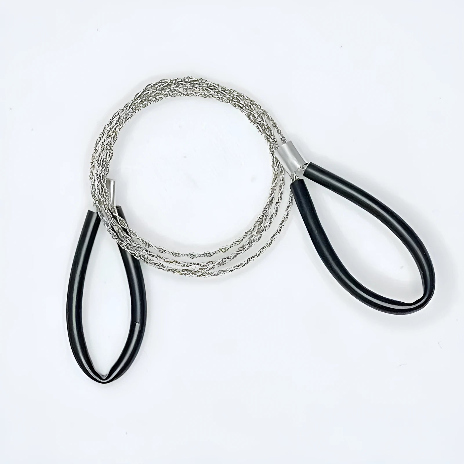 Close-up of a black and red stainless steel survival wire saw coiled in its storage bag.