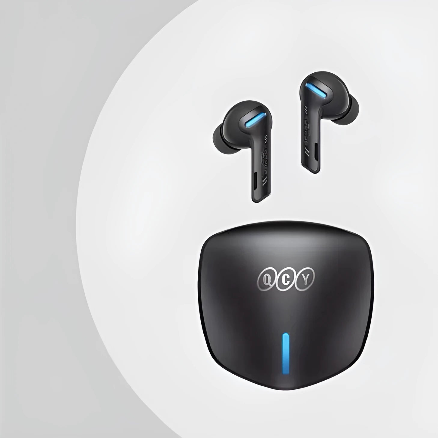 Grey QCY BH21G1A wireless Bluetooth gaming earbuds with their compact charging case on a table.