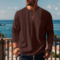 Man wearing a loose solid-colour cotton linen pullover beach shirt on a casual day out.