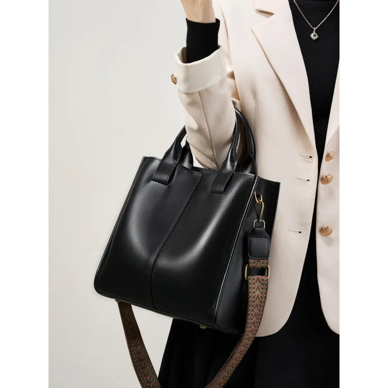 Women's genuine leather shoulder tote bag in black colour showing bucket design and polyester lining