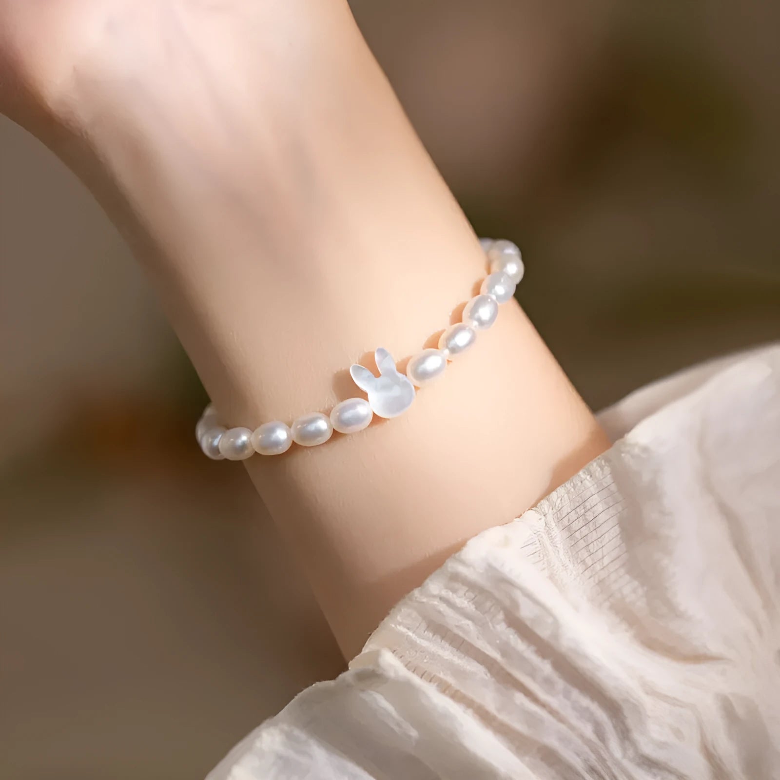 Handmade women's rabbit bracelet with 925 silver charm and white shell pearl beads on elastic string