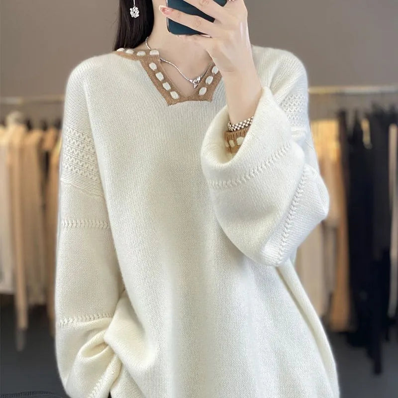 Women's camel coloured V-neck long sleeve viscose knit sweater on a hanger.