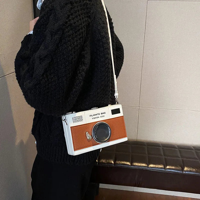 Soft black PU leather mini crossbody bag with a silver chain strap in a horizontal square shape.