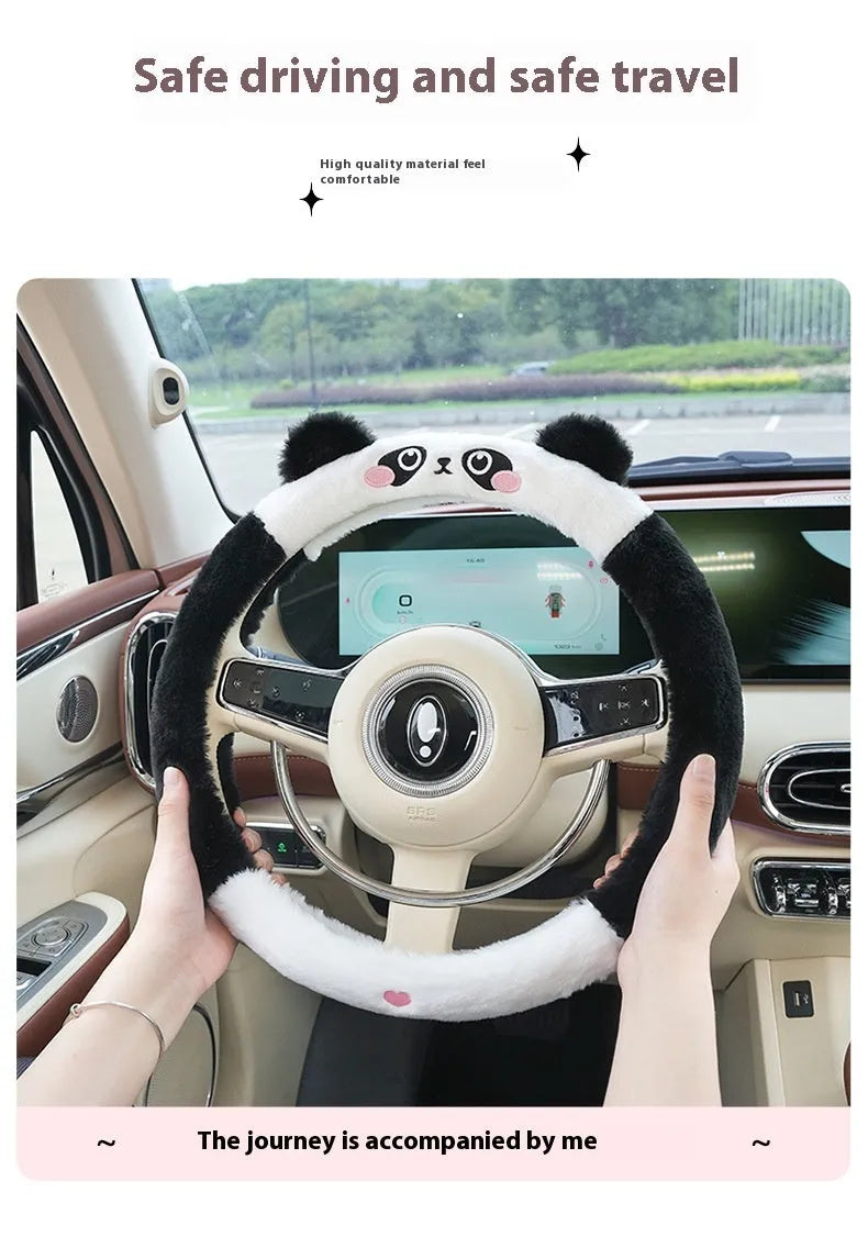 Plush winter steering wheel cover with embroidered bear design, shown on a car steering wheel.