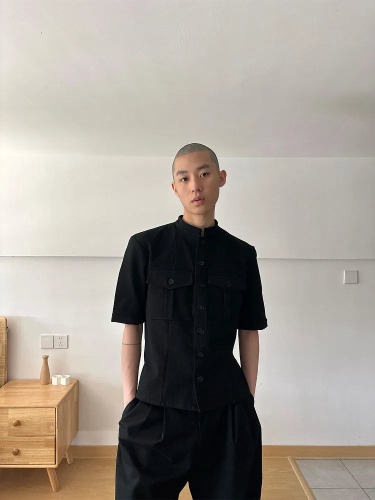 Handmade black loose-fit half sleeve hunting shirt with a shirt collar on a hanger.