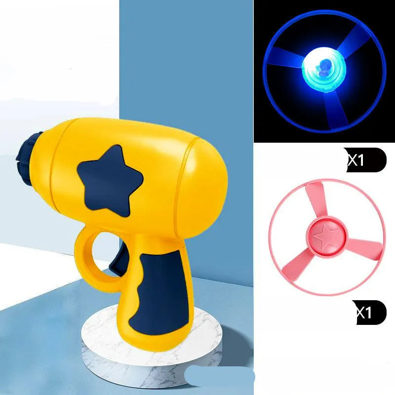 Blue LED flying saucer launcher toy set with gun, three luminous discs, and target board on packaging.