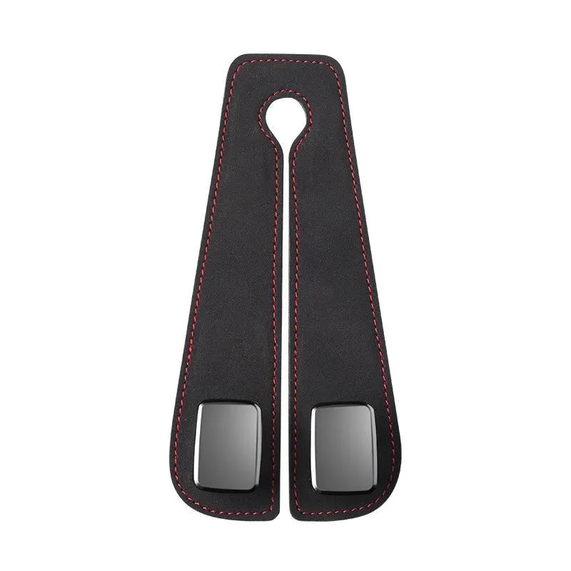 Black alloy car seat hook with suede covering attached to a grey car seatback.