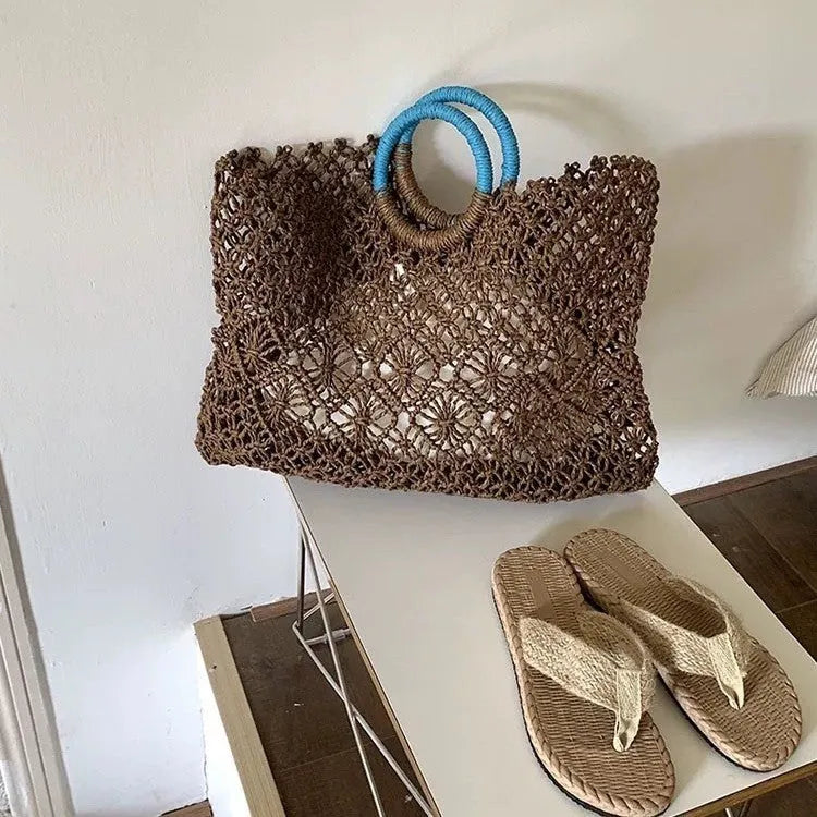 Dark brown handmade straw tote bag with square vertical shape and sandwich pocket design