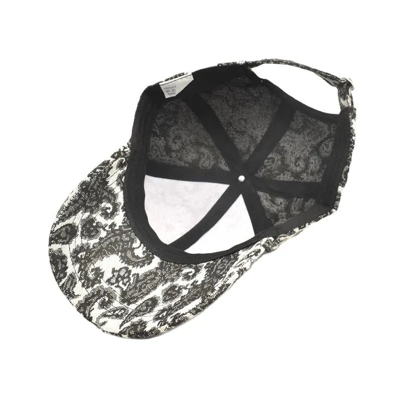 Blue paisley print polyester baseball cap with a dome crown, shown from the side.