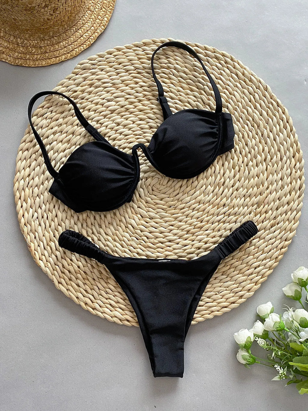 Women's black underwire bikini swimsuit with split brief style on a mannequin.