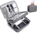 Grey waterproof electronics organiser bag with double-layer interior, handle, and zipper closure