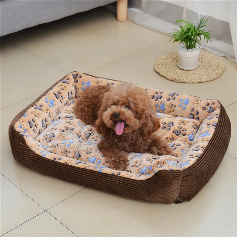 Beige sofa-style plush pet bed for small dogs with raised basket edges on a wooden floor.