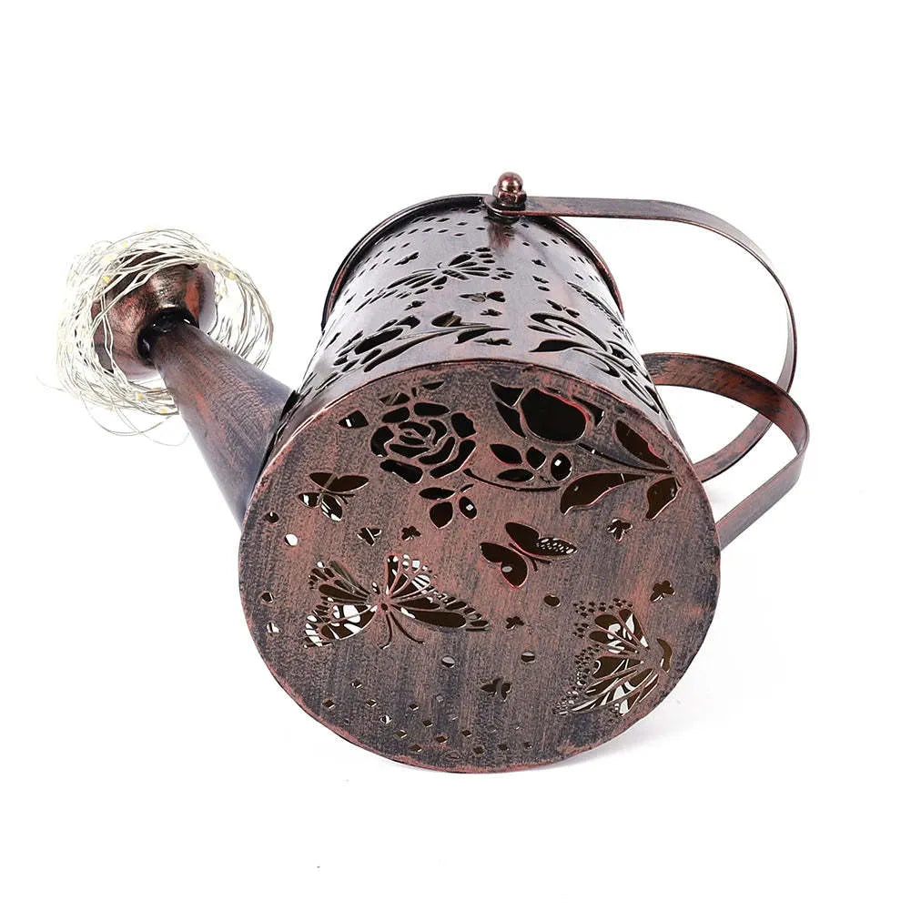 Solar garden lamp with iron butterfly design and warm white LED light for outdoor use.
